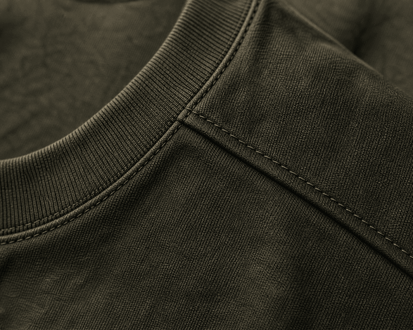 Macro detail of the DYRWOLF Olive T-Shirt fabric and stitching