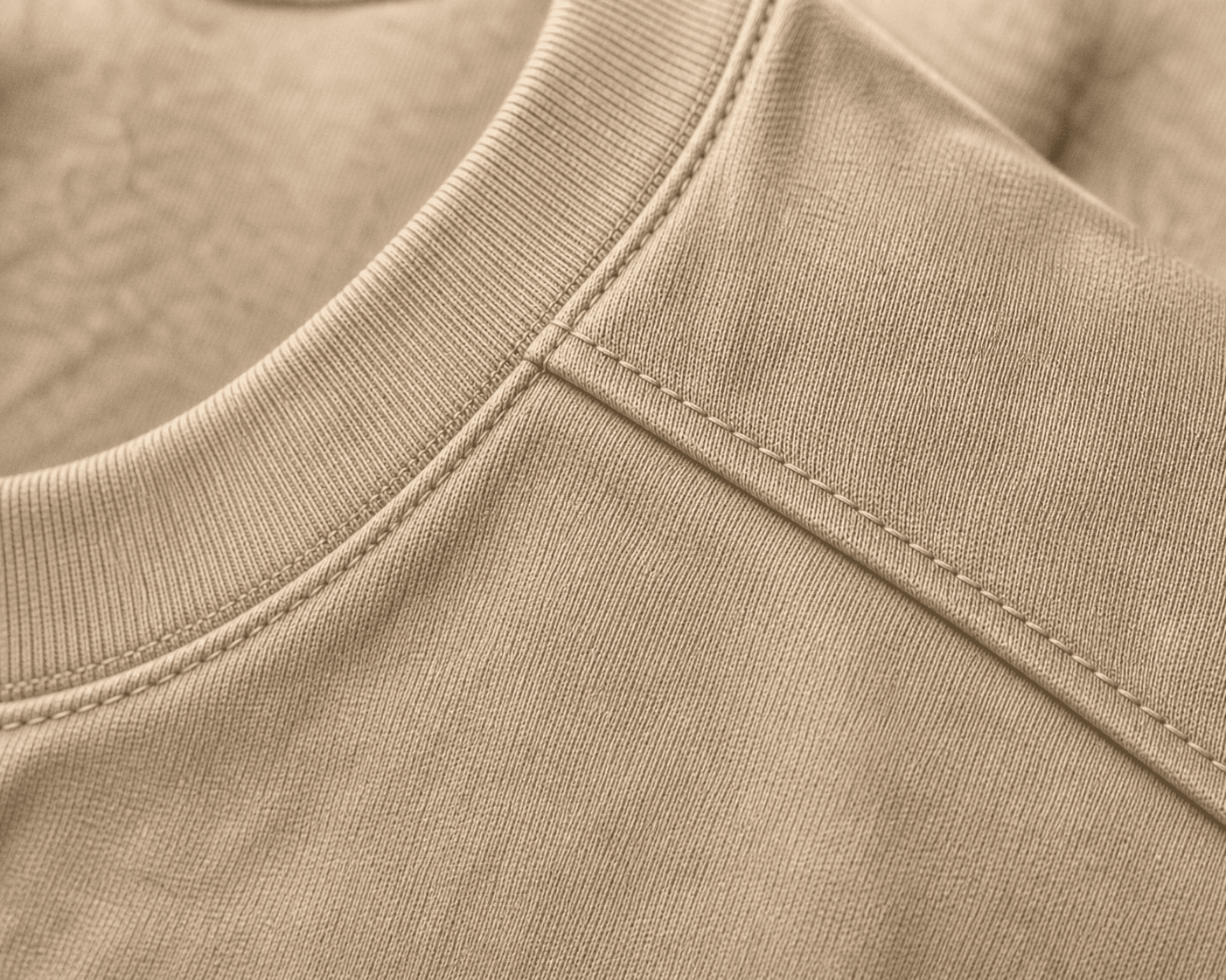 Macro detail of the DYRWOLF Sand T-Shirt fabric and stitching